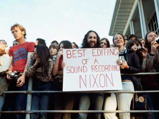 A spectator holds up a sign at the Academy Awards, April 1974